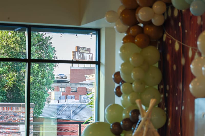 The Historic Downtown McKinney sign seen through the venue windows
